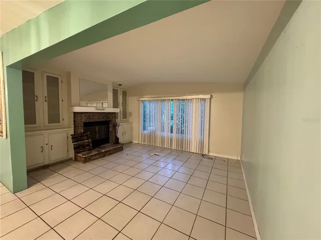 a view of a hallway with wooden floor and cabinet