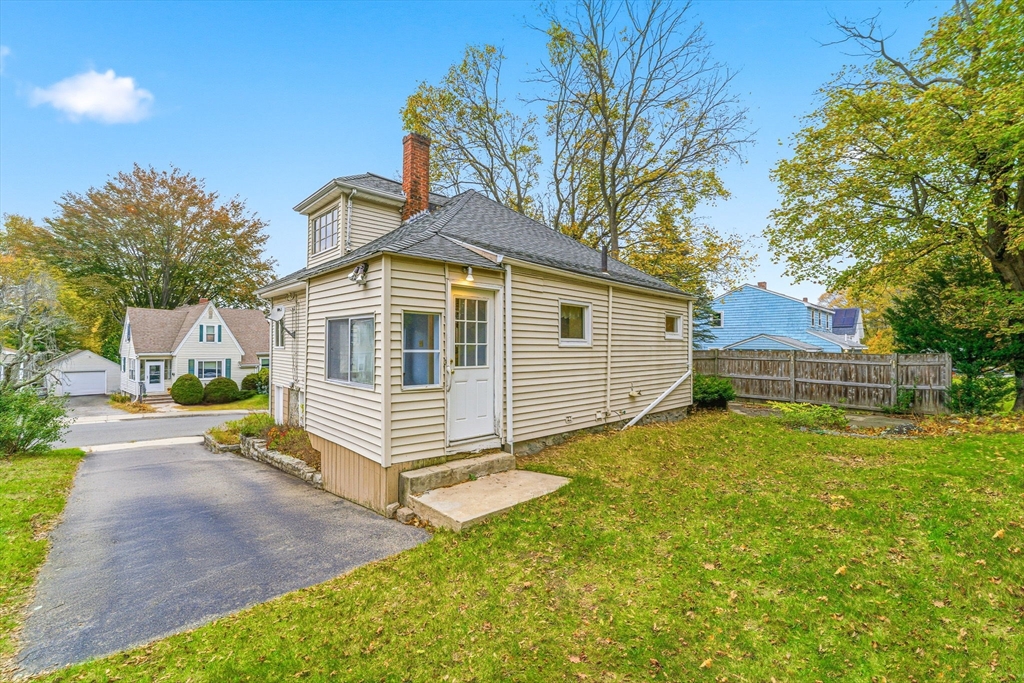 5 Springdale Avenue Saugus, MA 01906 - Photo 5 of 25 a front view of a house with a yard and garage