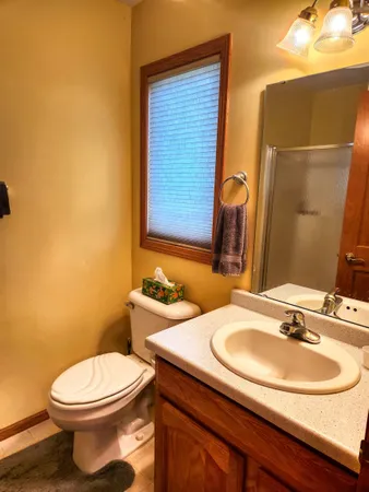 a bedroom with furniture and a lamp