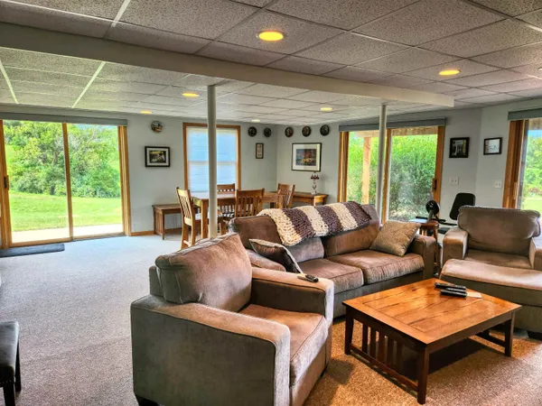 a view of a livingroom with furniture and a large window