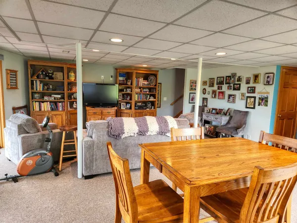 a kitchen with stainless steel appliances granite countertop a refrigerator a sink and a window