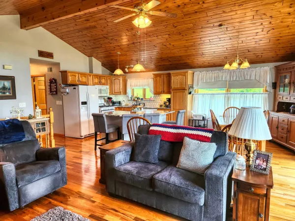 a living room with furniture a flat screen tv and a floor to ceiling window