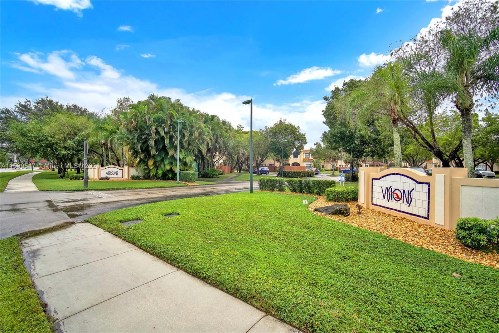 a sign board with grassy area