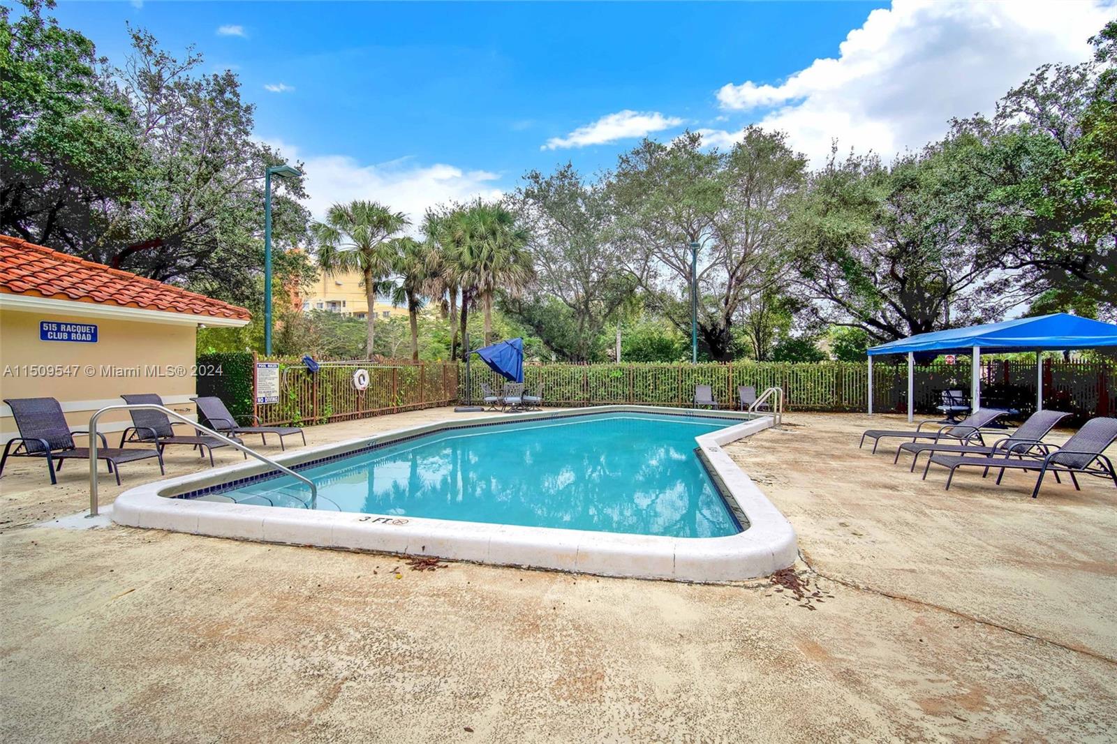 549 Racquet Club Road, Unit 31 Weston, FL 33326 - Photo 2 of 4 an outdoor space with swimming pool and furniture