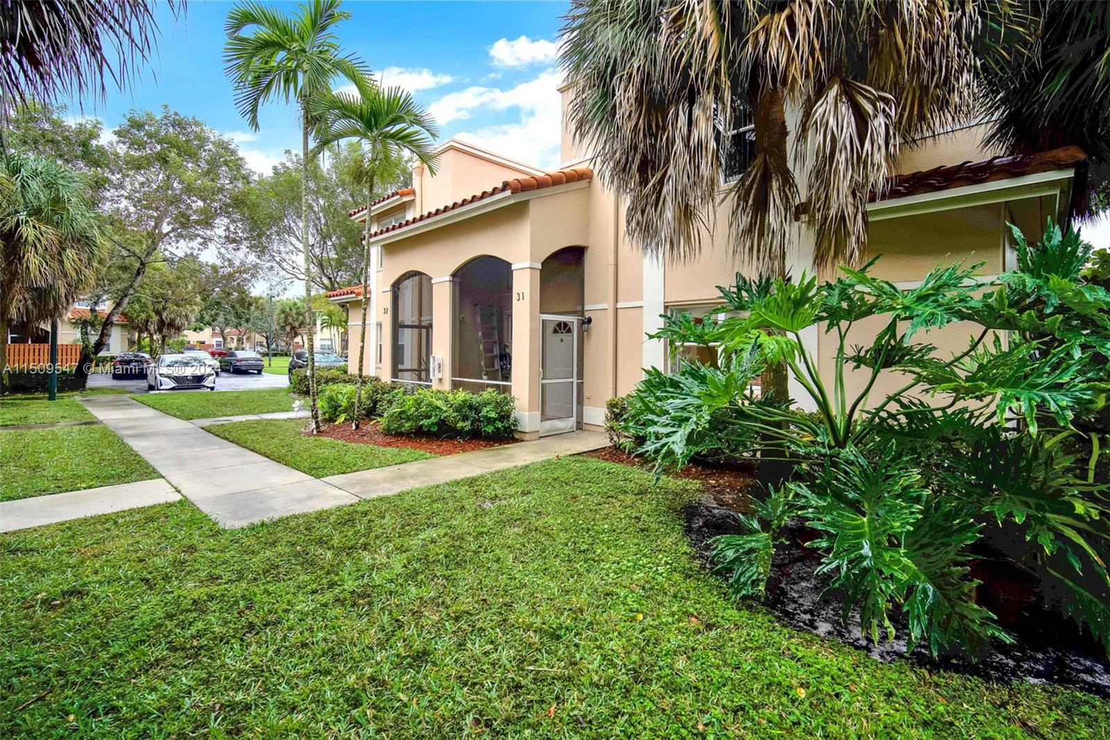 549 Racquet Club Road, Unit 31 Weston, FL 33326 - Photo 3 of 4 a view of a yard in front of house
