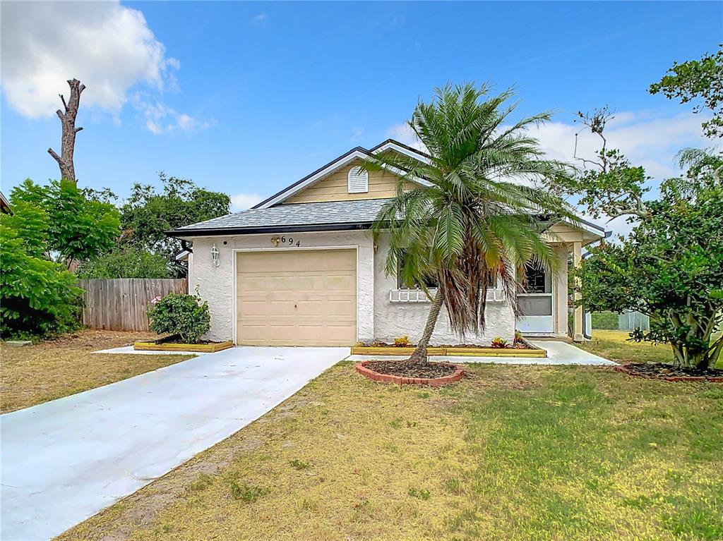 694 Merlins Court Tarpon Springs, FL 34689 - Photo 1 of 1 a view of a house with a yard and palm trees