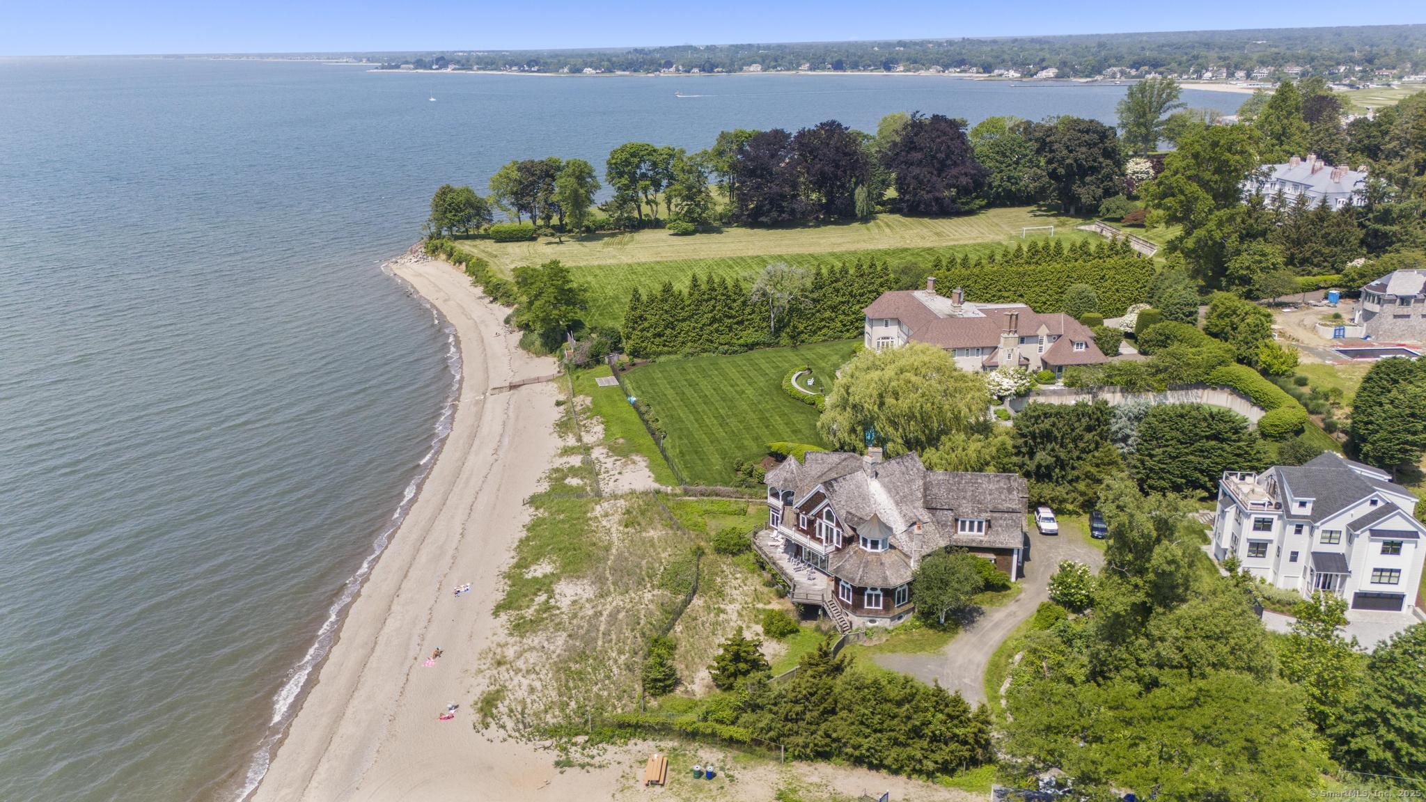 1410 South Pine Creek Road Fairfield, CT 06824 - Photo 11 of 40 an aerial view of a house with outdoor space swimming pool lake and green space