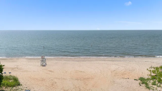 an aerial view of a house with a big yard and large trees