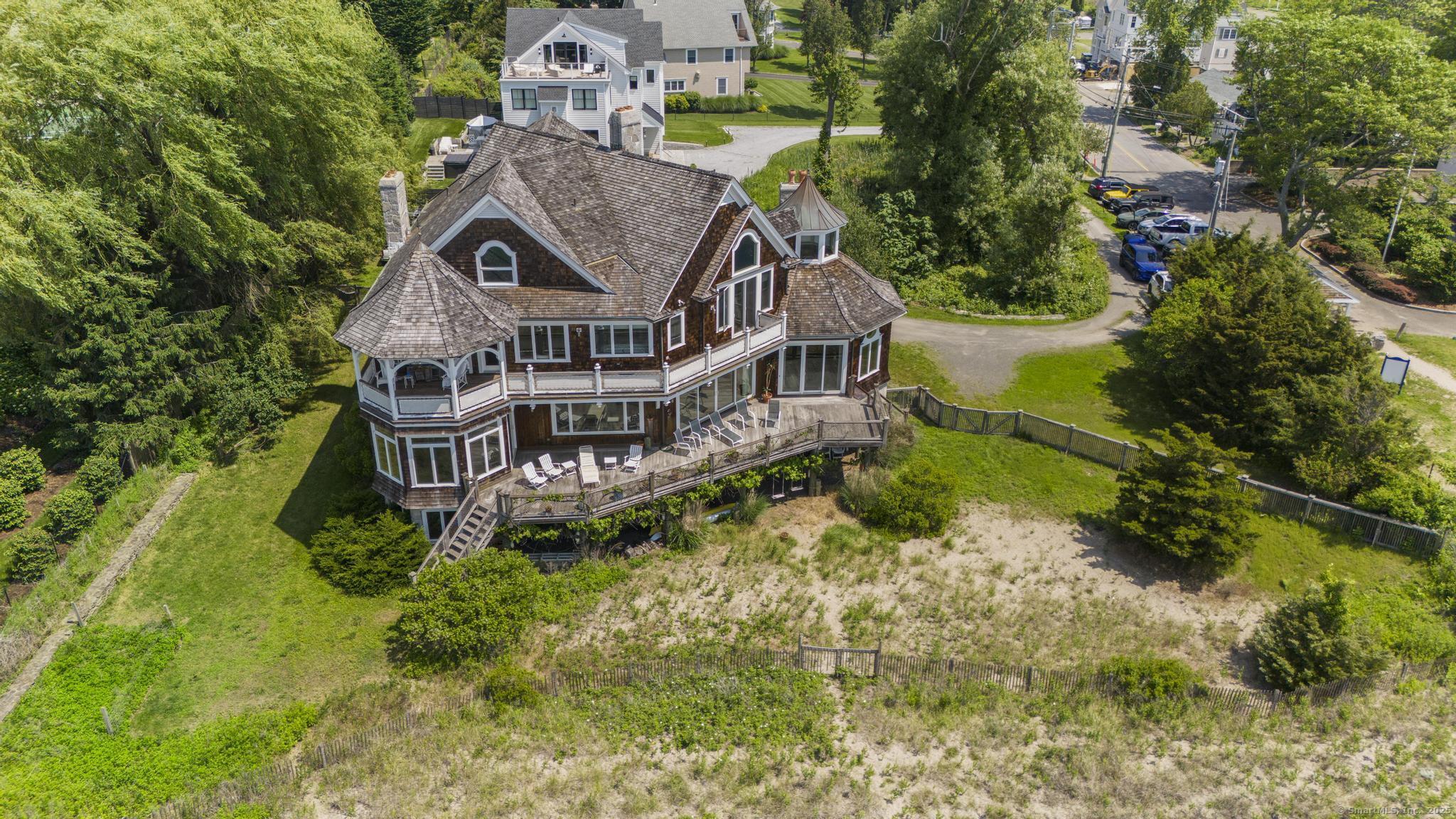 1410 South Pine Creek Road Fairfield, CT 06824 - Photo 17 of 40 an aerial view of a house with a big yard and large trees