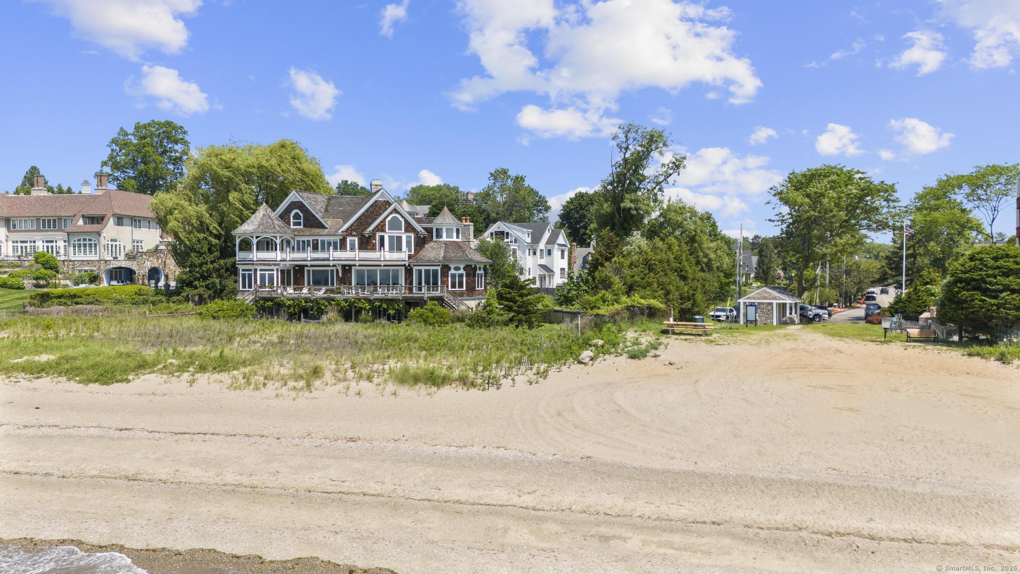 1410 South Pine Creek Road Fairfield, CT 06824 - Photo 18 of 40 a front view of a house with a yard