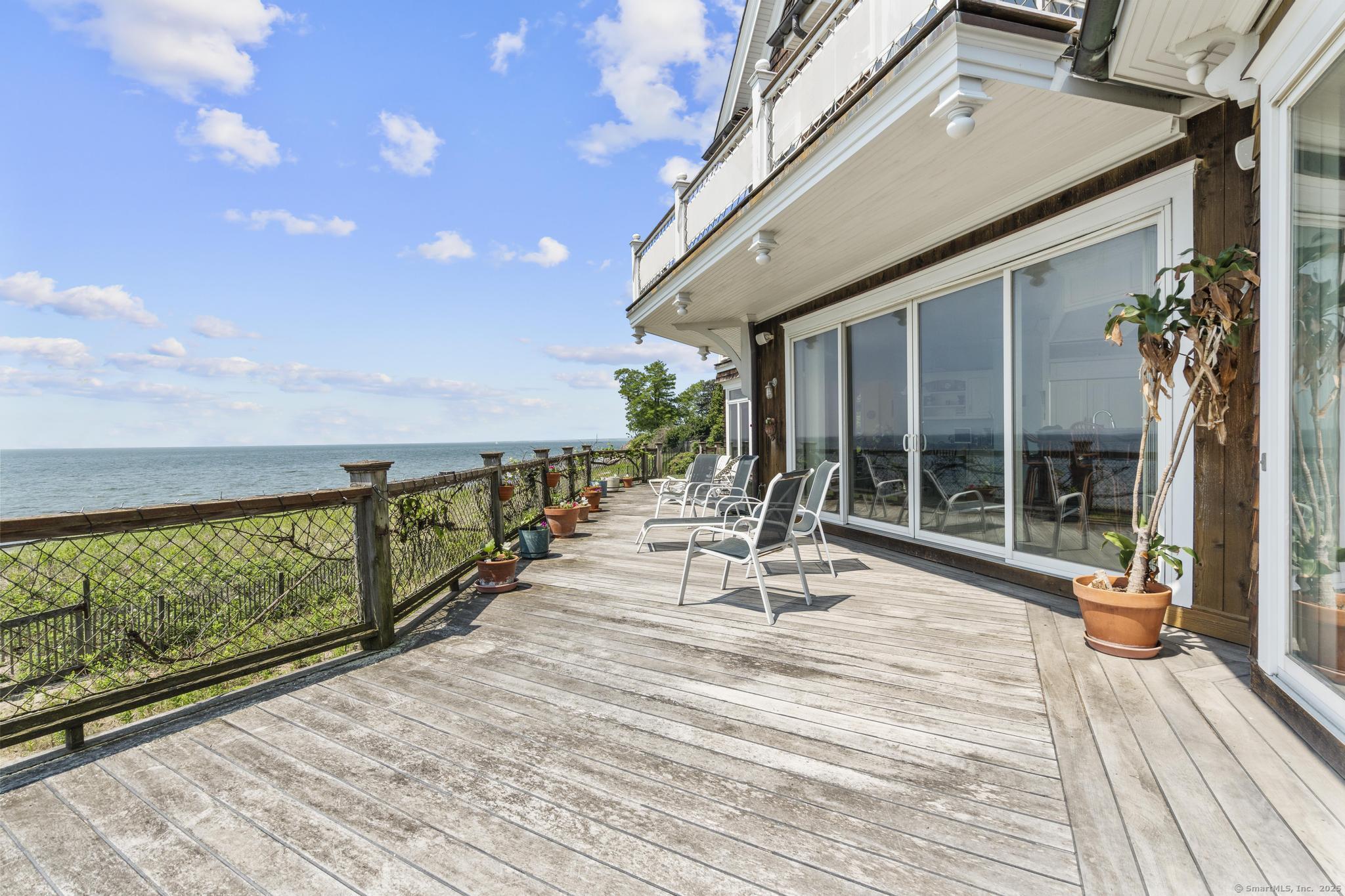 1410 South Pine Creek Road Fairfield, CT 06824 - Photo 20 of 40 a view of swimming pool with outdoor seating and wooden floor
