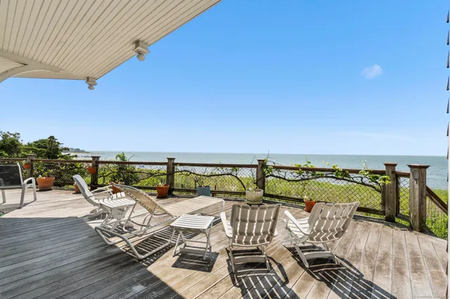 a living room with furniture ceiling fan and a large window