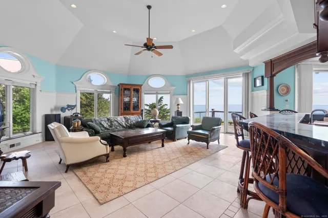 a kitchen with kitchen island granite countertop a stove and a sink
