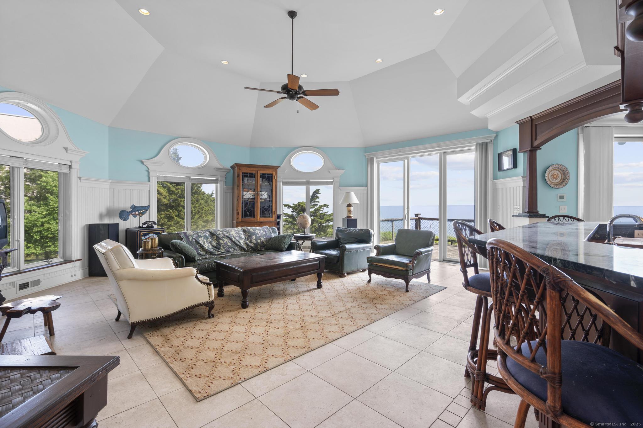1410 South Pine Creek Road Fairfield, CT 06824 - Photo 23 of 40 a living room with lots of furniture and a large window