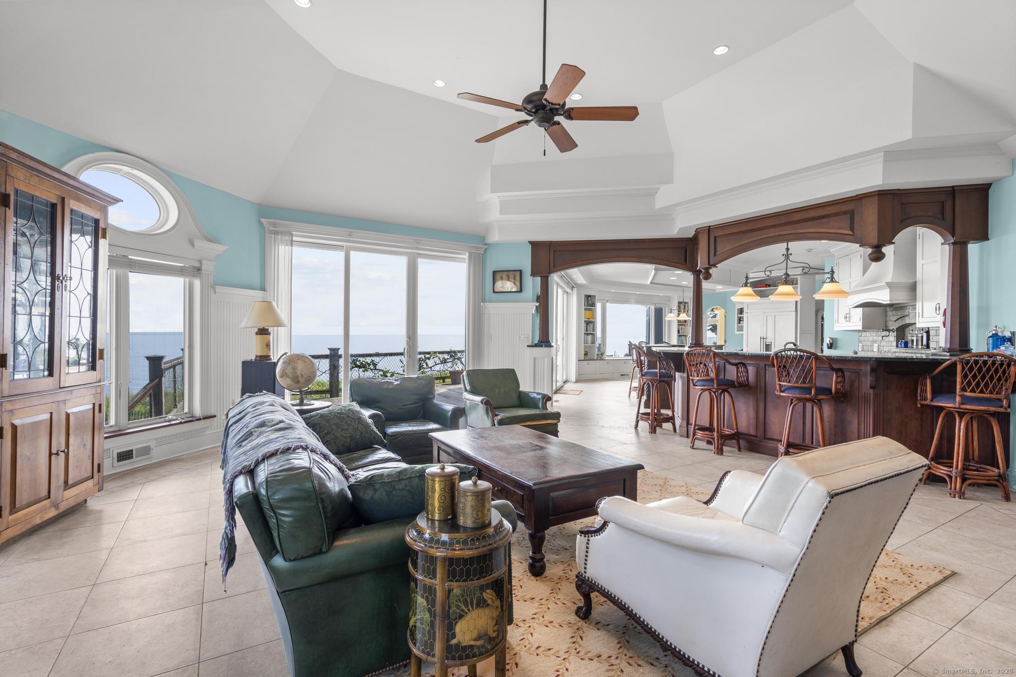 1410 South Pine Creek Road Fairfield, CT 06824 - Photo 24 of 40 a living room with furniture ceiling fan and a large window