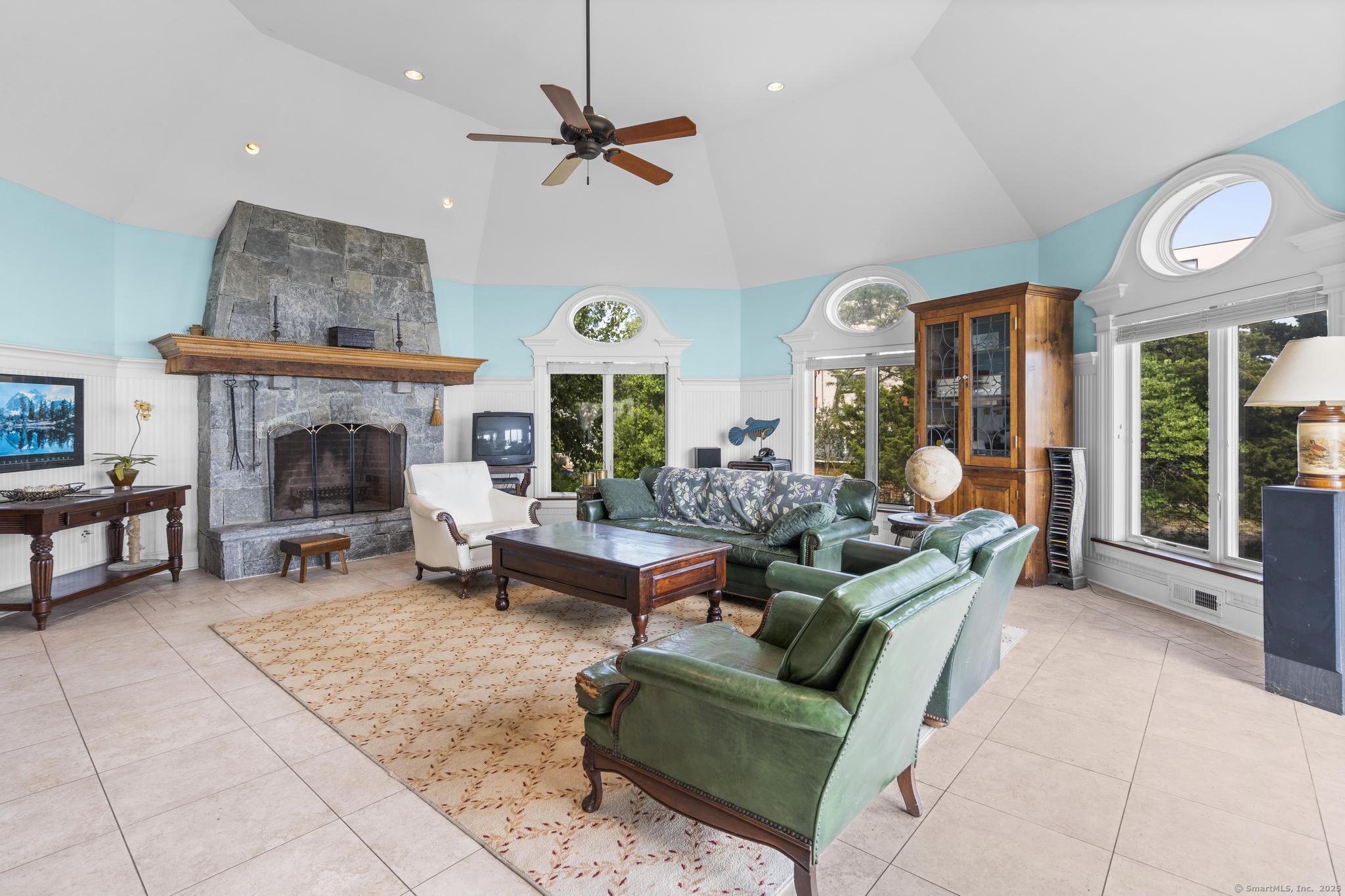 1410 South Pine Creek Road Fairfield, CT 06824 - Photo 25 of 40 a living room with furniture and a fireplace