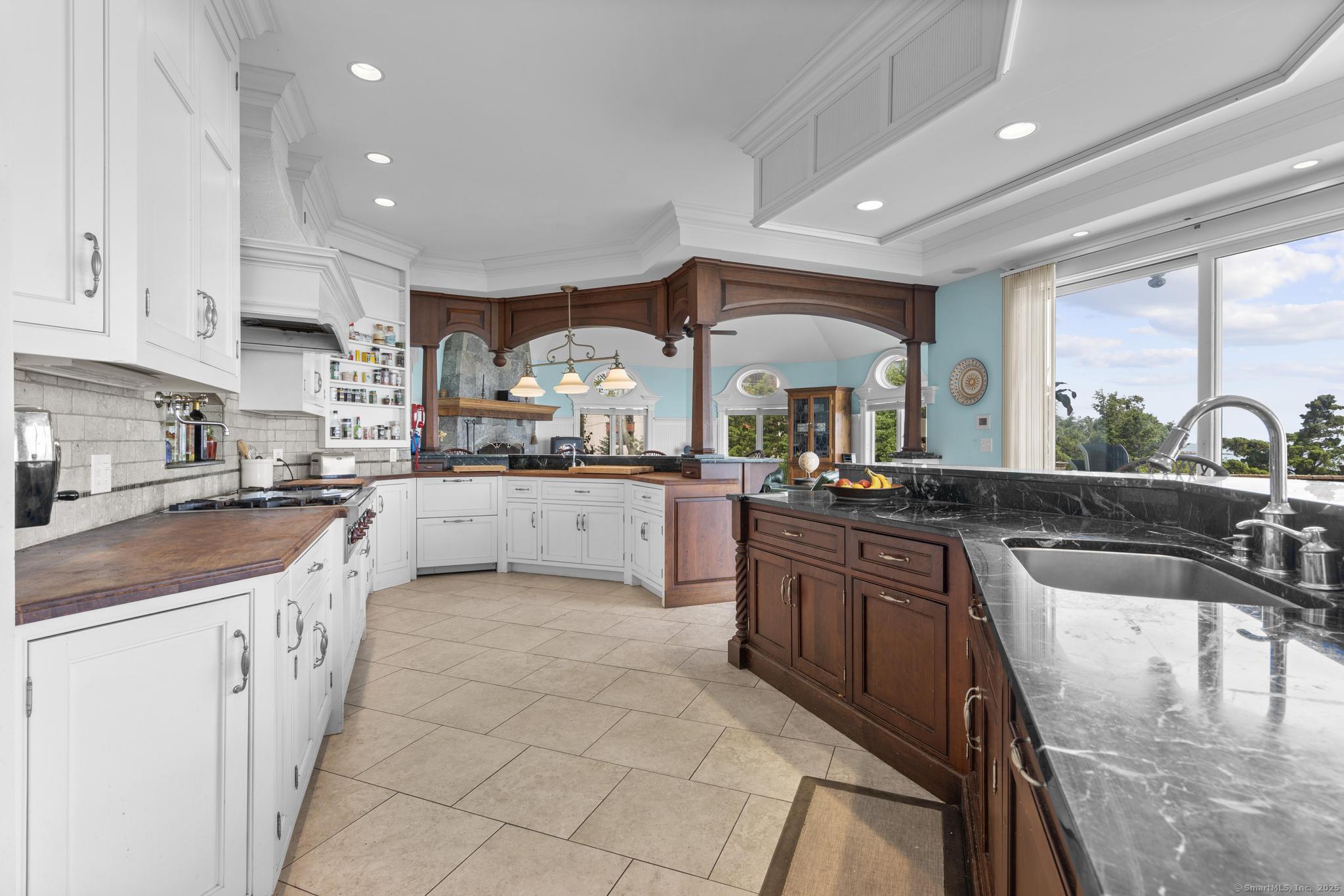 1410 South Pine Creek Road Fairfield, CT 06824 - Photo 27 of 40 a large kitchen with stainless steel appliances lots of counter top space a sink and cabinets