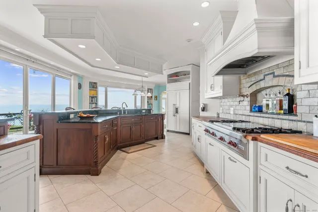 a dining room with furniture and a large window