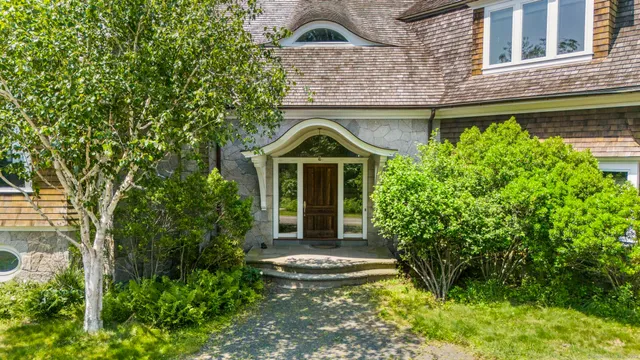 a front view of a house with a garden