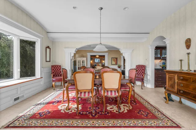 a dining room with furniture and window
