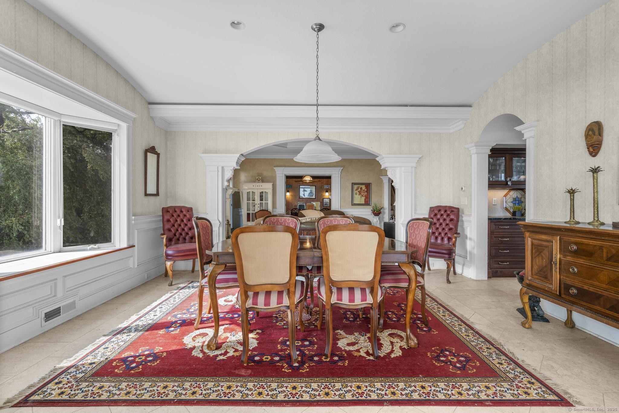 1410 South Pine Creek Road Fairfield, CT 06824 - Photo 33 of 40 a dining room with furniture a rug a rug and a window