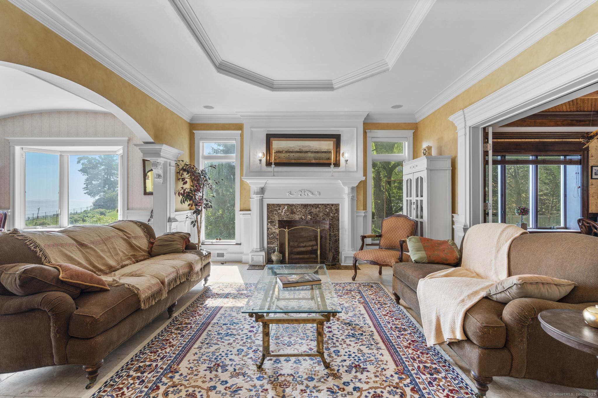 1410 South Pine Creek Road Fairfield, CT 06824 - Photo 35 of 40 a living room with furniture and a fireplace