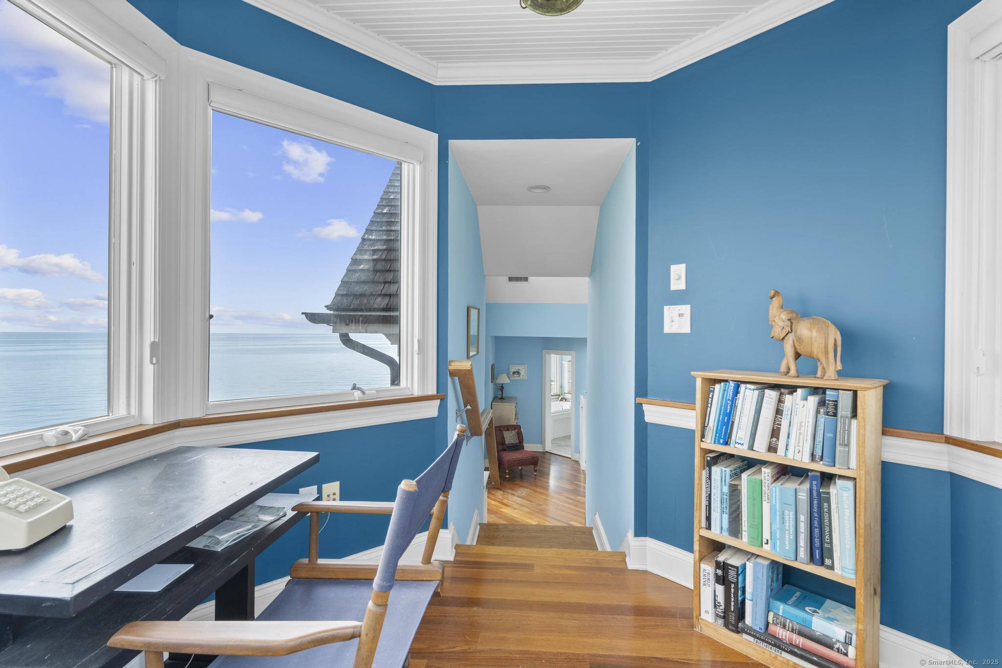 1410 South Pine Creek Road Fairfield, CT 06824 - Photo 37 of 40 a room with furniture and a book shelf