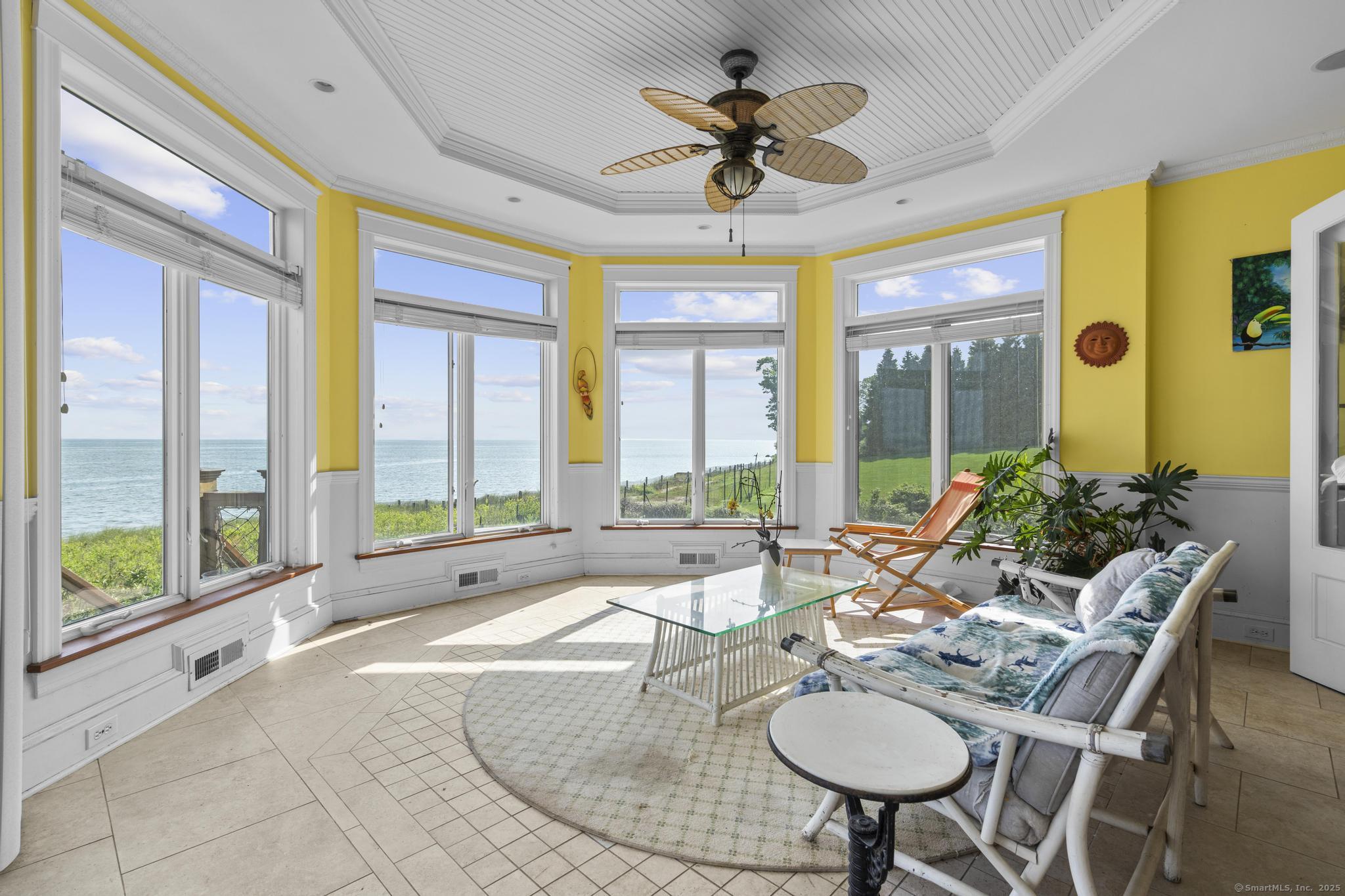 1410 South Pine Creek Road Fairfield, CT 06824 - Photo 37 of 40 a living room with furniture and a large window