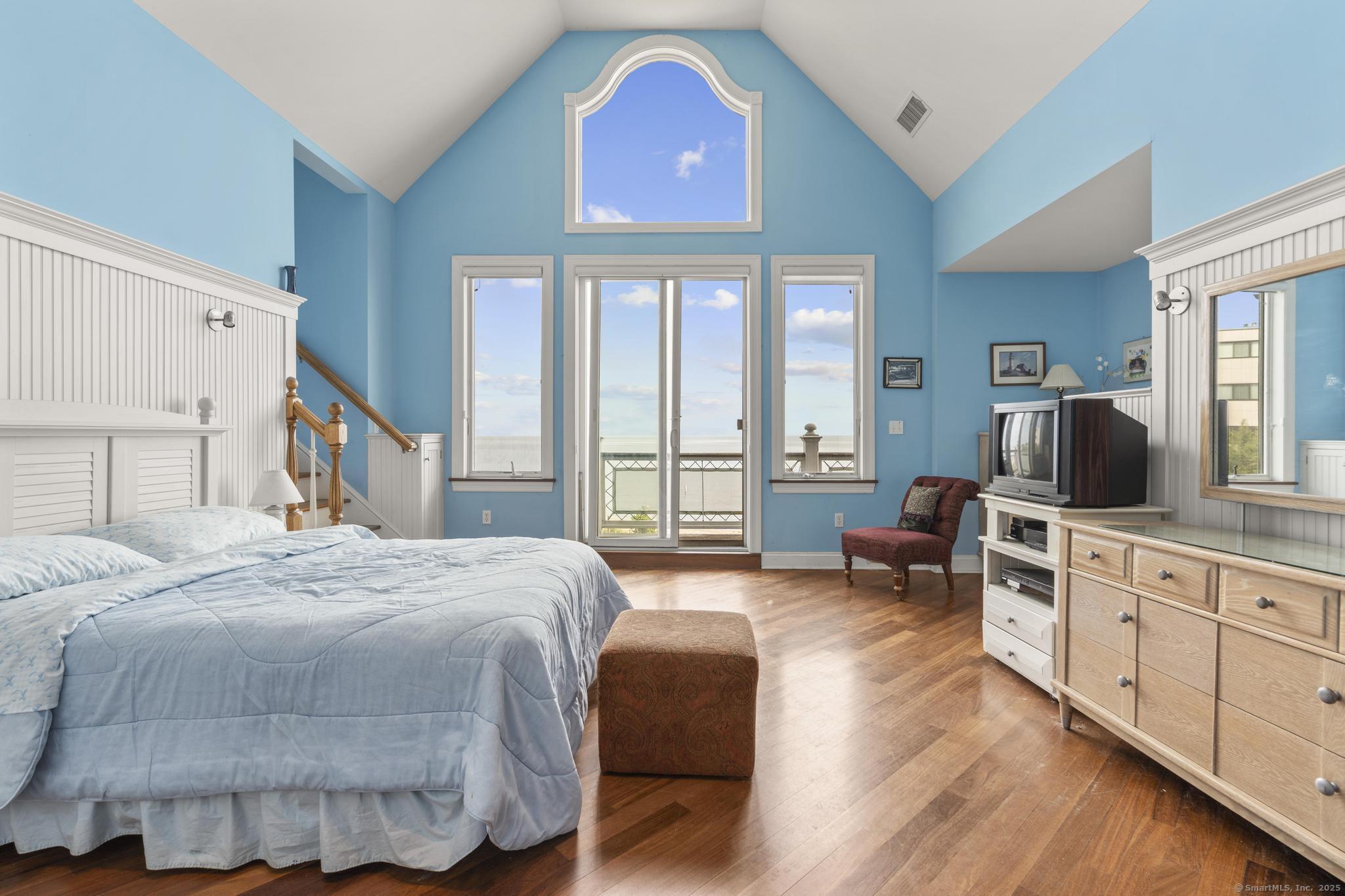 1410 South Pine Creek Road Fairfield, CT 06824 - Photo 38 of 40 a bedroom with a bed and a flat screen tv