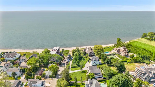 an aerial view of a house with a garden and lake view