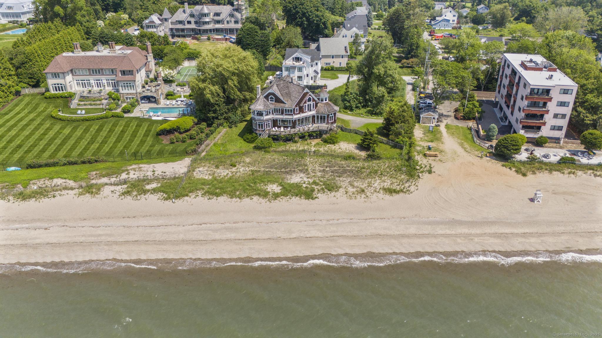 1410 South Pine Creek Road Fairfield, CT 06824 - Photo 10 of 40 an aerial view of a house with a garden and lake view
