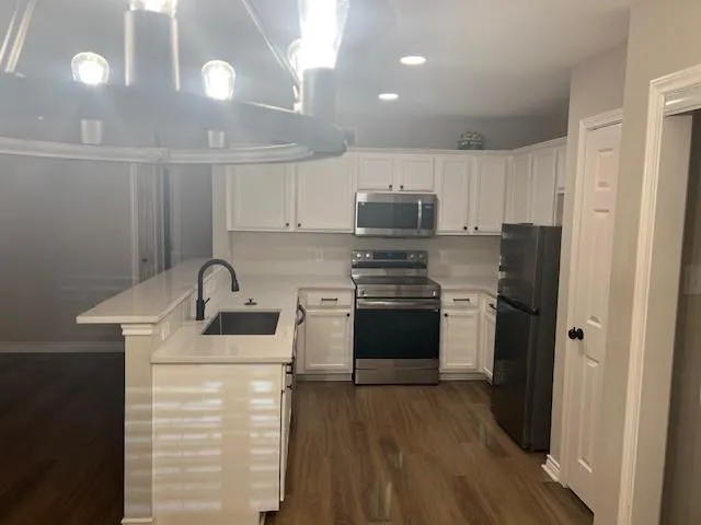 a kitchen with stainless steel appliances a refrigerator sink and stove