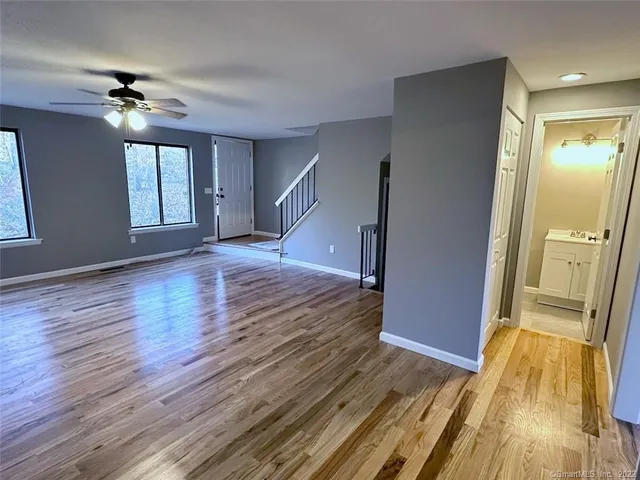 a view of empty room with wooden floor