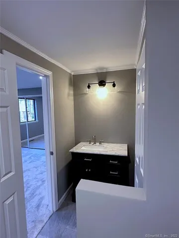 a room with a sink and mirror