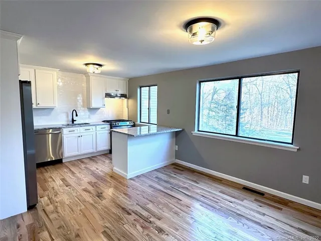 a large kitchen with a large window