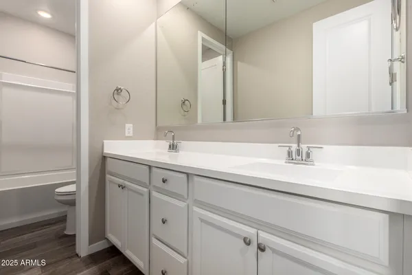 an empty room with chandelier fan