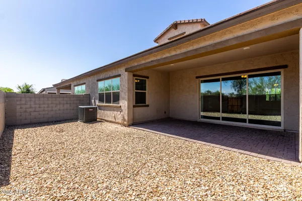 an empty room with fan and windows