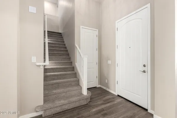 an empty room with wooden floor and window