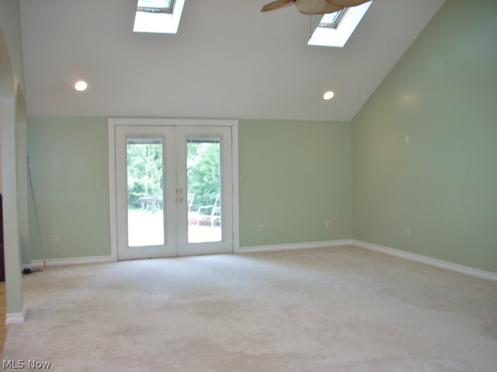 6931 North Ridge Road East Geneva, OH 44041 - Photo 7 of 25 North or back yard end of the great room with spacious brick patio just past the french doors. Inside the wall to the right there is a space set up for inserting a fireplace with a flue.