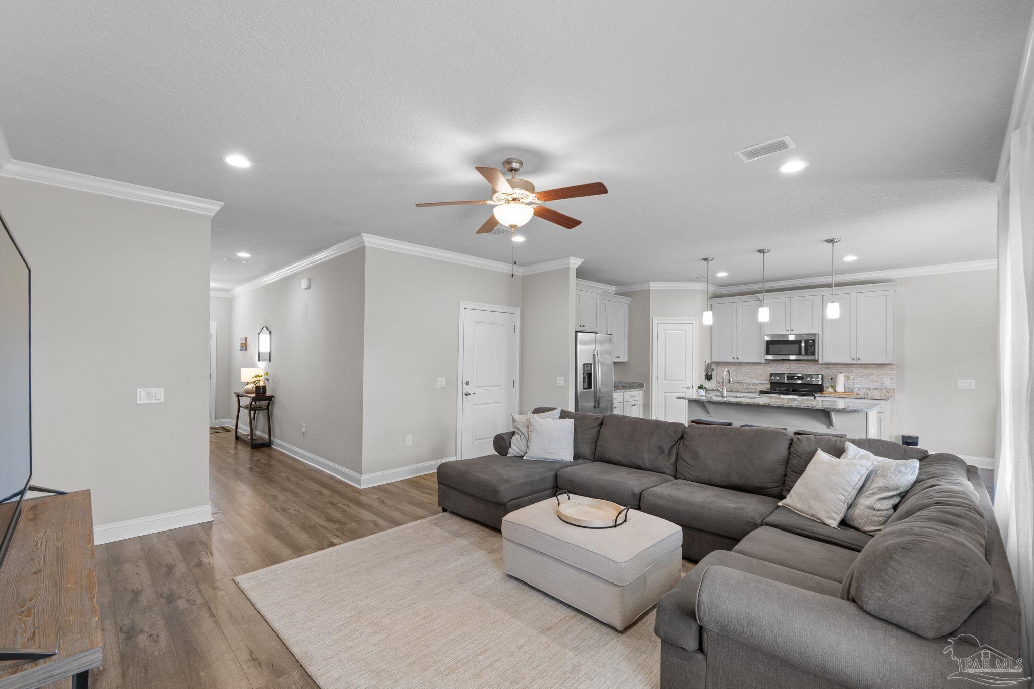 2770 Joe Pruitt Road Navarre, FL 32566 - Photo 11 of 58 a living room with furniture and kitchen view