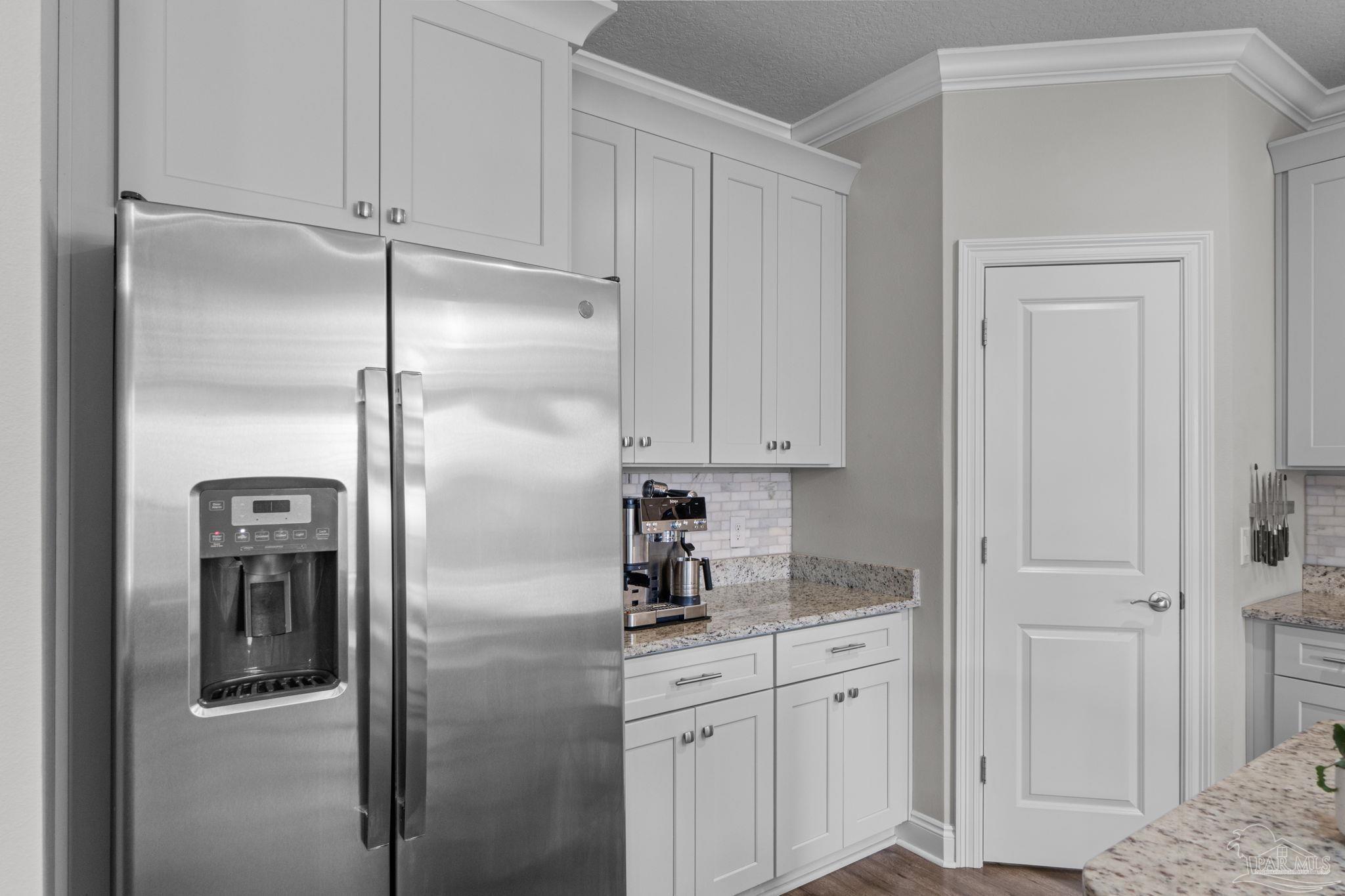 2770 Joe Pruitt Road Navarre, FL 32566 - Photo 16 of 58 a kitchen with cabinets and a refrigerator