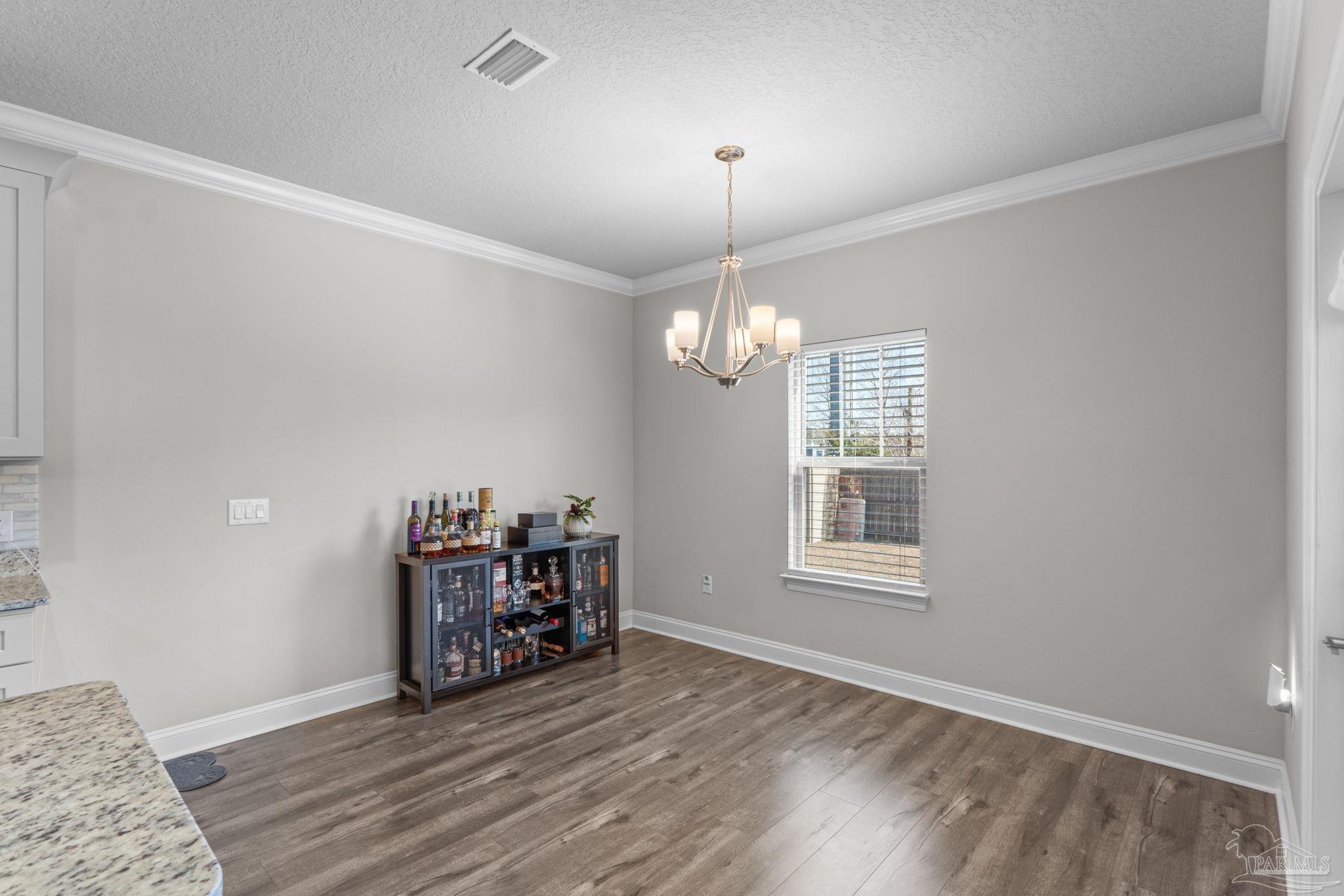 2770 Joe Pruitt Road Navarre, FL 32566 - Photo 19 of 58 a view of a livingroom with hardwood floor and chandelier