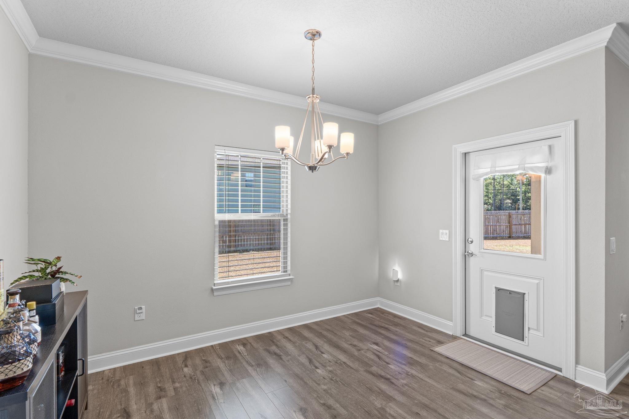 2770 Joe Pruitt Road Navarre, FL 32566 - Photo 20 of 58 a view of empty room with wooden floor and fan