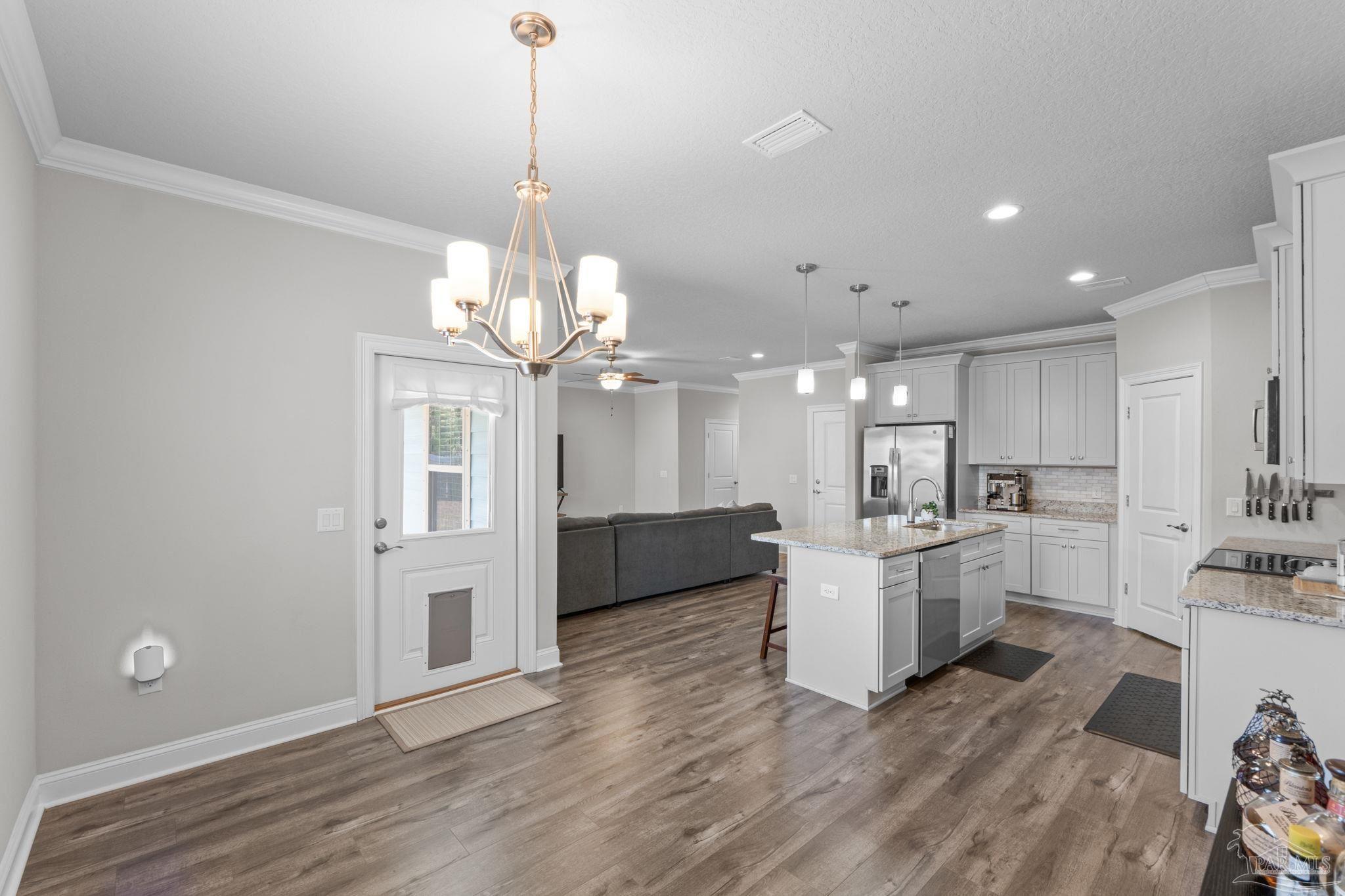 2770 Joe Pruitt Road Navarre, FL 32566 - Photo 21 of 58 a view of a kitchen with cabinets and wooden floor