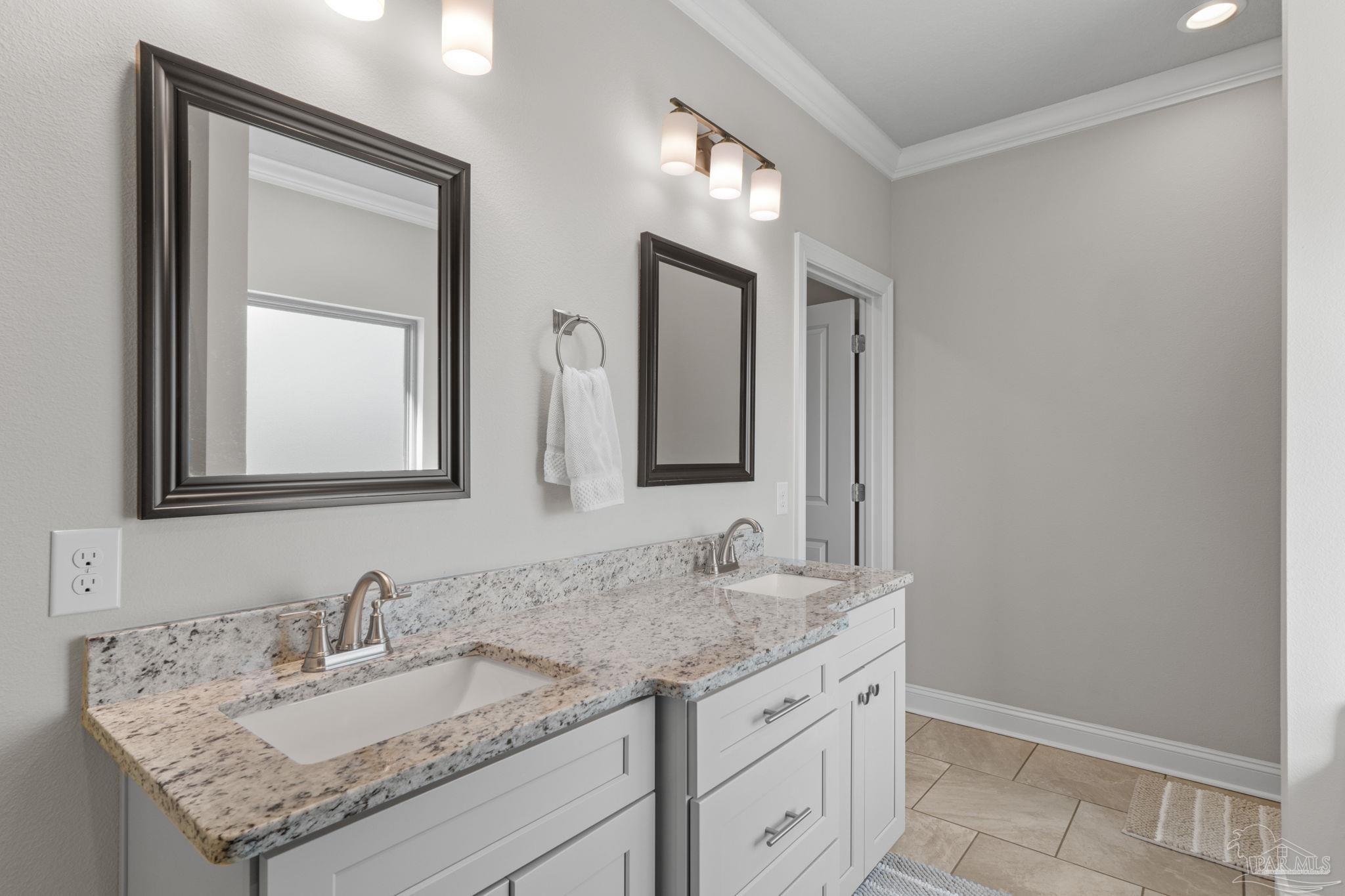 2770 Joe Pruitt Road Navarre, FL 32566 - Photo 27 of 58 a bathroom with a granite countertop sink and a mirror