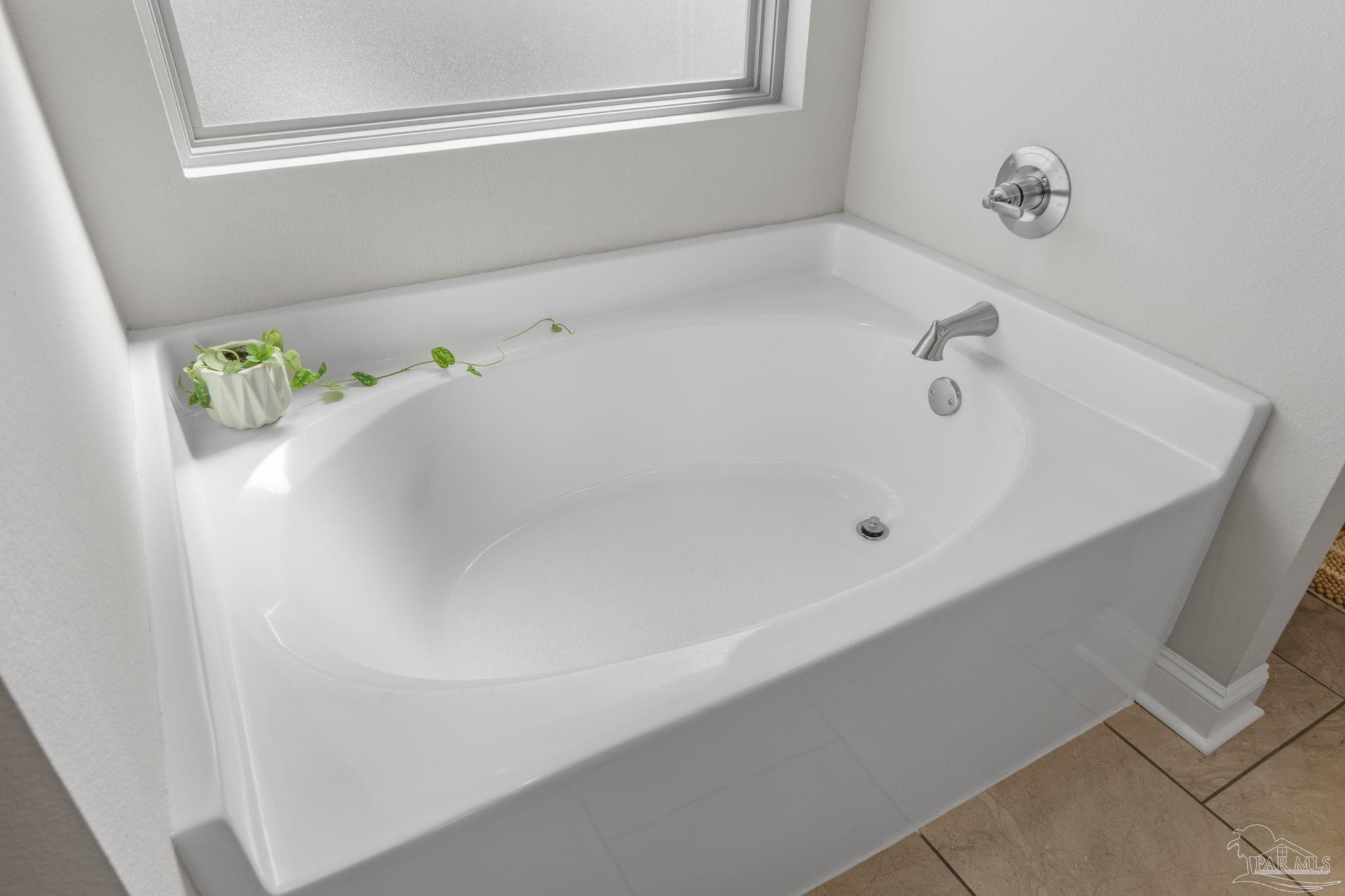 2770 Joe Pruitt Road Navarre, FL 32566 - Photo 29 of 58 a white bath tub sitting in a bathroom