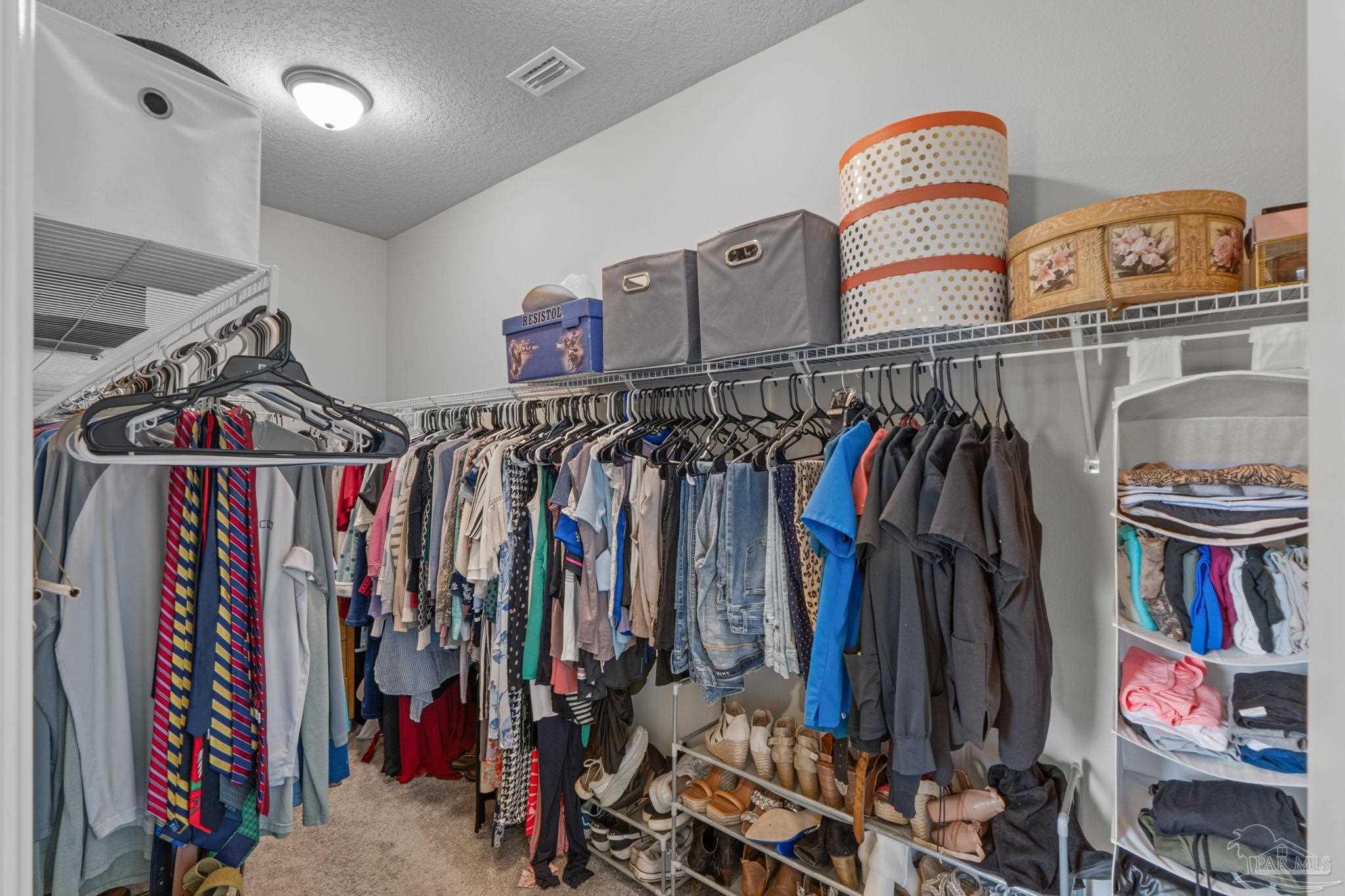 2770 Joe Pruitt Road Navarre, FL 32566 - Photo 31 of 58 a view of walk in closet with clothes