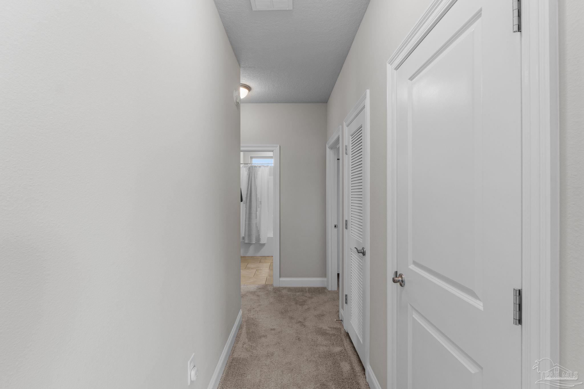 2770 Joe Pruitt Road Navarre, FL 32566 - Photo 33 of 58 a view of a hallway with closet and wooden floor