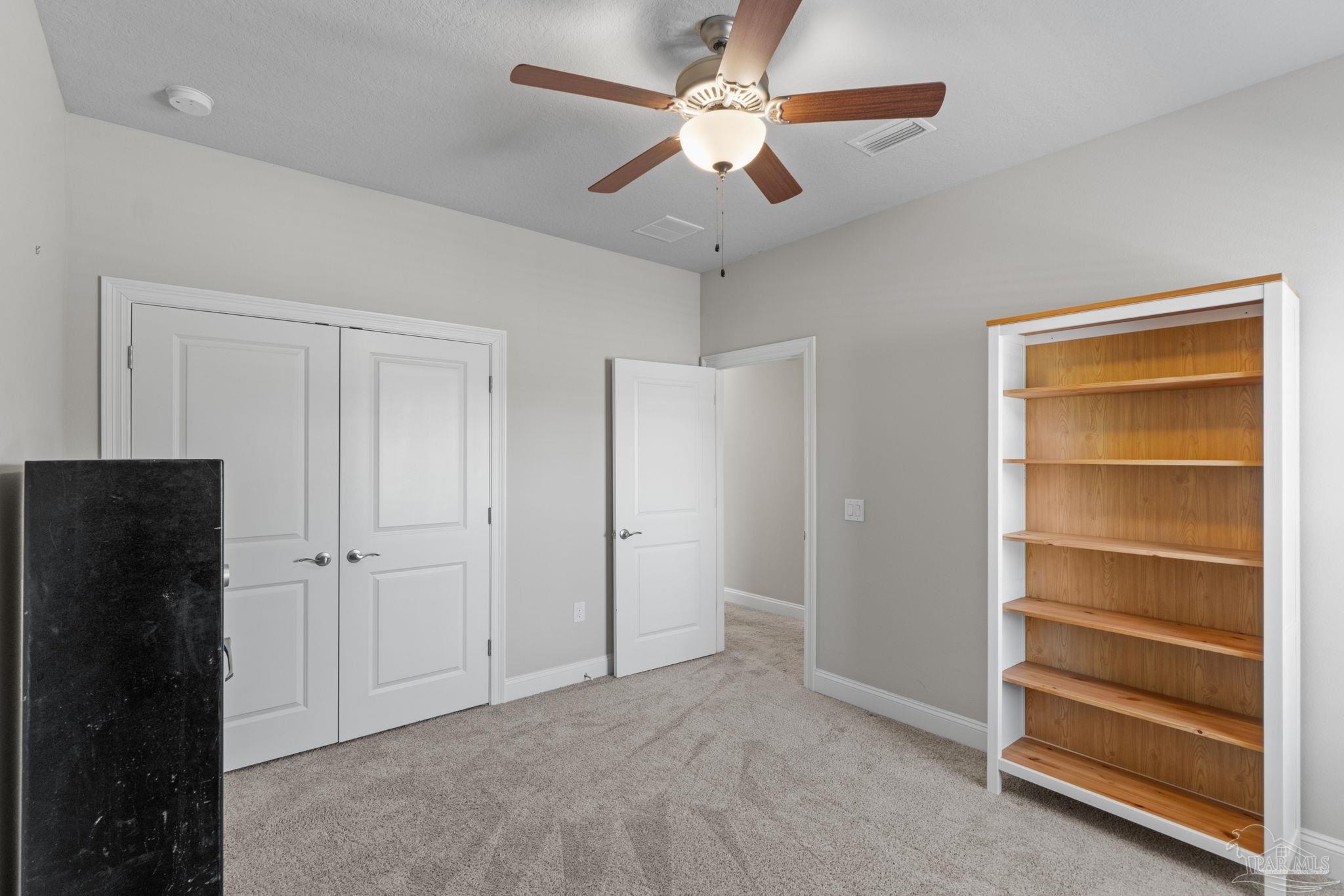 2770 Joe Pruitt Road Navarre, FL 32566 - Photo 41 of 58 a view of an empty room with a ceiling fan