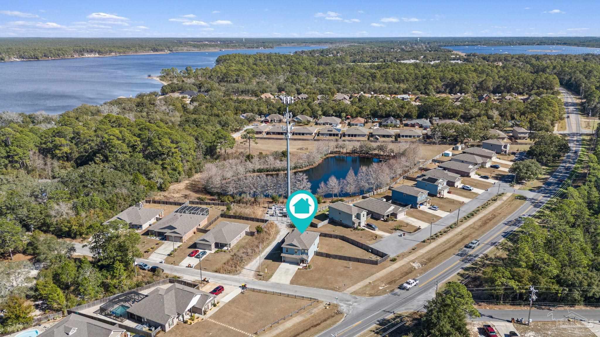 2770 Joe Pruitt Road Navarre, FL 32566 - Photo 53 of 58 an aerial view of a house with a lake view